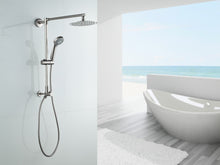 Load image into Gallery viewer, Fennocasa Polaris 1 brushed nickel rain shower head with handheld wand combo in white brightly lit bathroom with a big white bath tub and ocean view.
